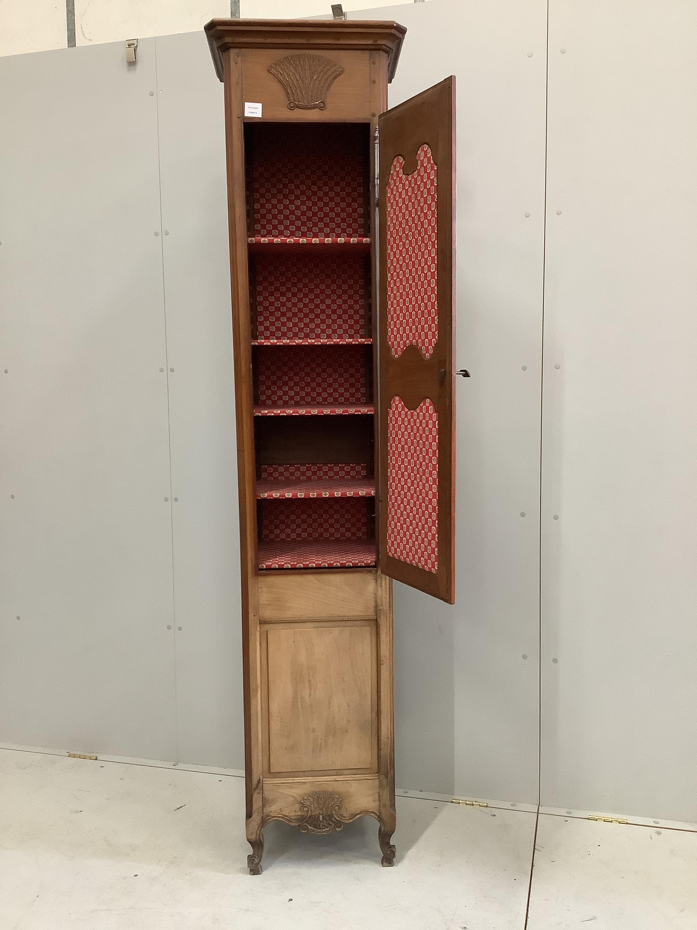 A Louis XV style narrow walnut cabinet, width 48cm, depth 36cm, height 215cm